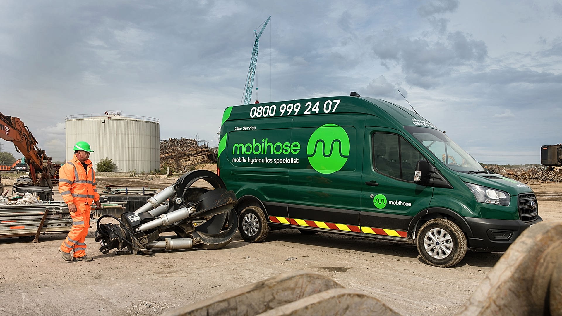03-Mobile-hydraulic-hose-repair-1920 Green Mobihose van with engineer next to hydraulic demolition attachment.