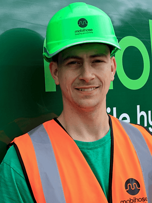 Alex Stephens, Mobihose engineer in front of green van.
